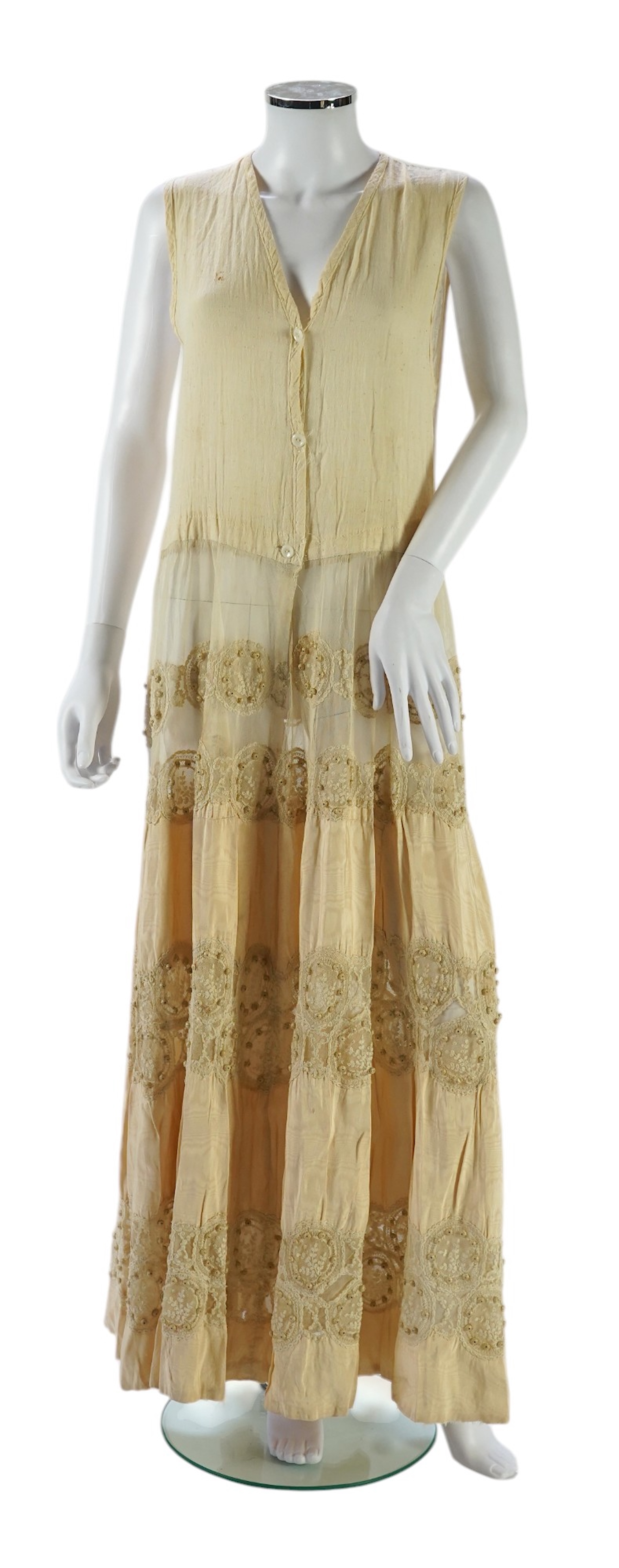 A suitcase containing a cream silk lace skirt to a dress, an Edwardian silk petticoat and various collars, possibly for theatrical use, silk petticoat 96 cm long. Condition - fair